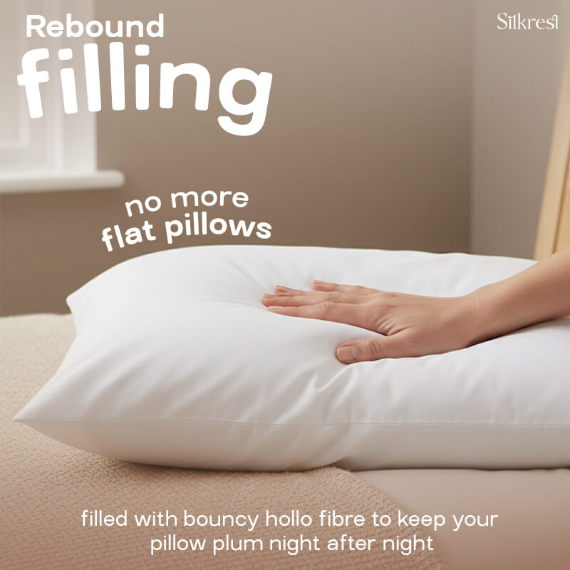 A hand pressing into a fluffy Silkrest pillow to demonstrate its rebound filling, designed to prevent flat pillows