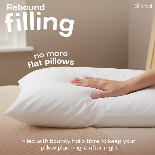 A hand pressing into a fluffy Silkrest pillow to demonstrate its rebound filling, designed to prevent flat pillows